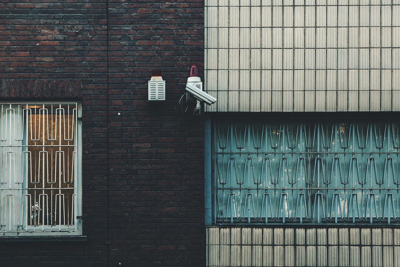 CCTV bullet security camera mounted on industrial building exterior wall