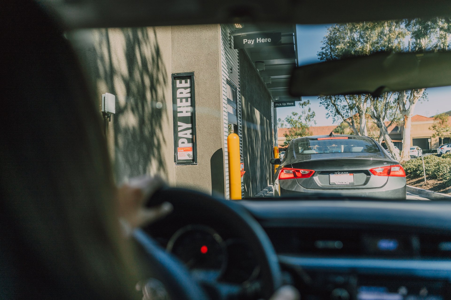 Drive-thru queue at fast food restaurant, daytime view